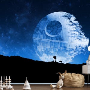 May include: A Star Wars-themed wall mural depicting the Death Star against a blue starry sky. Silhouetted figures and a black landscape are in the foreground. Decorative lights and a white nightstand are visible.