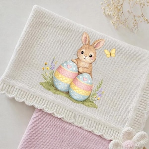 May include: A set of three ceramic mugs with a speckled, matte finish. The mugs are in shades of cream, light grey, and dark grey. Each mug has a simple, minimalist design, ideal for coffee or tea.