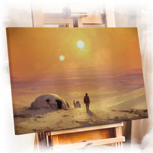 May include: A rectangular wrapped canvas print featuring a desert landscape with two suns in an orange sky. A figure stands near a small domed structure and a robotic companion on the sandy terrain. The text GALLERY WRAPPED CANVAS is visible.