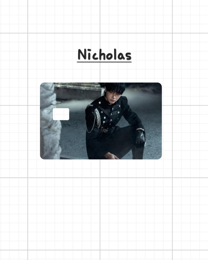 May include: A card with the name "Nicholas" in black script. The card features a person in a black military-style jacket with silver buttons and chain detail. The background is a blurred outdoor scene.