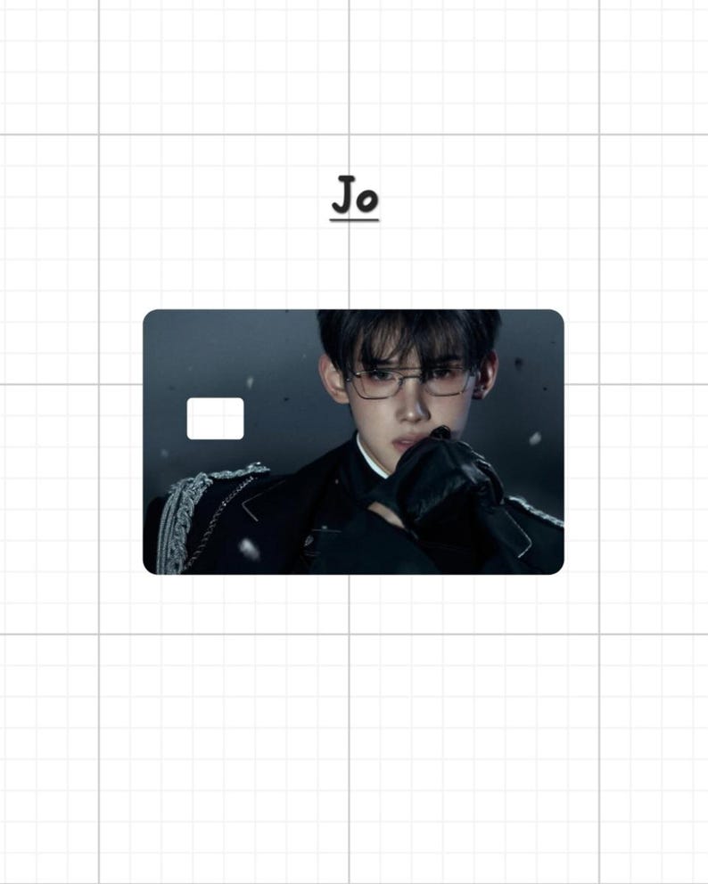 May include: A rectangular card with a portrait of a person wearing glasses and a black outfit. The card has a white rectangle in the upper left corner. The word "Jo" is above the card.