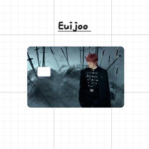 May include: A rectangular card with the name "Eui joo" in black text at the top. The card features a person in a black uniform with a cape, standing in a misty environment with swords. The background is a dark, dramatic scene.