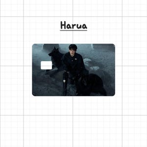 May include: A rectangular card with a dark image of a person in black clothing with two black dogs. The word "Harua" is written in black above the card. A white rectangle is on the card.