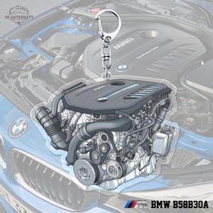 Peut inclure: Un porte-clés en acrylique transparent avec une illustration détaillée d'un moteur BMW. Le porte-clés a un fermoir argenté et un design de moteur détaillé. Le texte "BMW B58B30A" est affiché en bas.