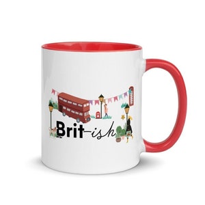 May include: White ceramic mug with a red rim and handle. The mug features a cartoon illustration of a red double-decker bus, streetlights, flags, and the text "Brit-ish".