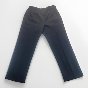 May include: Black dress pants with a straight leg design. The pants have a button and zipper closure at the waist. The fabric appears to be a solid, dark color, suitable for formal or business attire.