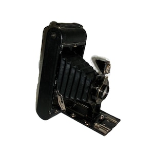May include: A vintage black folding camera with a bellows design. The camera has a rectangular body with a lens and a silver-colored metal base. The camera is open and ready for use, showcasing its intricate details and classic design.