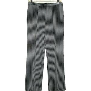 May include: Full-length trousers featuring a vertical striped pattern in black, white, and grey. The pants have a straight-leg cut, a simple waistband, and are displayed hanging on a clear plastic hanger against a plain white background.