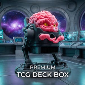 May include: A dark gray mechanical deck box featuring a pink, brain-shaped creature with yellow eyes and small white teeth. The creature has two pink tentacles extending forward. The text PREMIUM TCG DECK BOX is printed in white at the bottom.