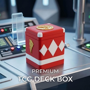 May include: A red square TCG deck box featuring a white horizontal stripe, three white diamond shapes, a gold lightning bolt emblem on the side, and a gold circular dinosaur fossil emblem on the lid. The text PREMIUM TCG DECK BOX is visible.
