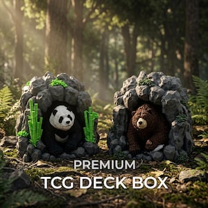 May include: Two gray rock-shaped TCG deck boxes featuring a panda bear with green bamboo stalks and a brown bear inside their respective cave-like openings. The text PREMIUM TCG DECK BOX is printed in white at the bottom of the image.