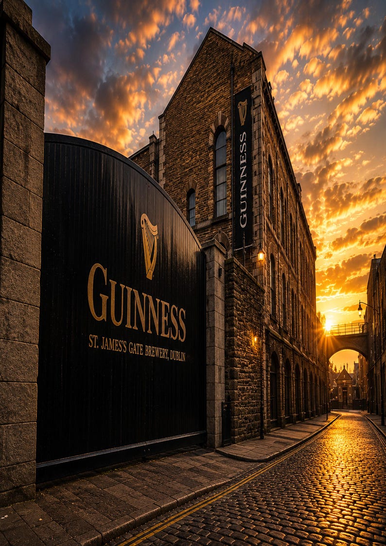 May include: A photograph of the Guinness brewery in Dublin, Ireland, at sunset. The image features a large black gate with the Guinness logo in gold, and a banner with the Guinness logo. The sky is filled with orange and yellow clouds.