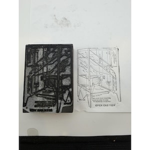 May include: A rectangular metal printing block featuring an engraved technical diagram of an industrial heating system, accompanied by a black ink impression on paper showing the same schematic with labels including Oil Pipe and Open End View.