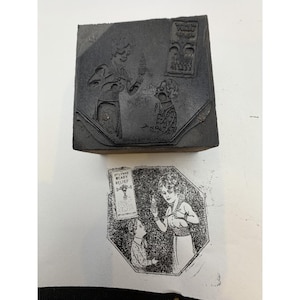 May include: A black printing block featuring an engraved illustration of a person holding a bottle and a child, with a rectangular sign labeled Dr. Lynas Ready Relief. Below the block is a black ink impression of the same detailed design.