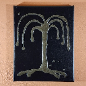 May include: A black canvas with a metallic gold tree design. The tree has a thick trunk and branches that curve downward, with drips at the ends. The artwork is mounted on a square canvas.