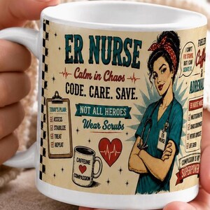 May include: A white ceramic mug featuring a graphic of a nurse with a stethoscope, a checklist, a heart, and a coffee cup. The text reads ER NURSE, Calm in Chaos, CODE. CARE. SAVE., NOT ALL HEROES WEAR SCRUBS, and CAFFEINE COMPASSION.