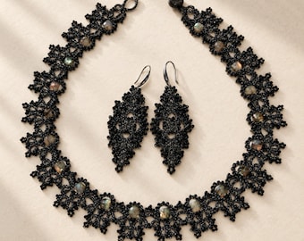 Handgemaakte sieradenset van zwarte spinel en labradoriet, bestaande uit een ketting, oorbellen en een ring van kantwerk.