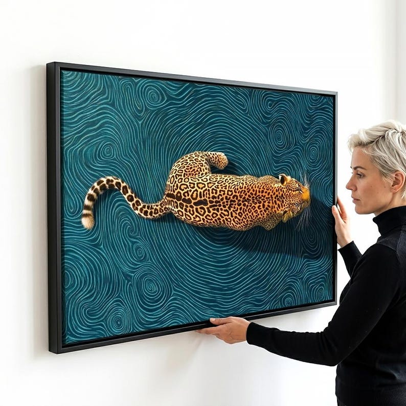 May include: A rectangular framed wall art piece featuring a leopard with a spotted coat positioned centrally against a deep teal background filled with intricate, swirling, wave-like patterns that create a sense of movement and depth.