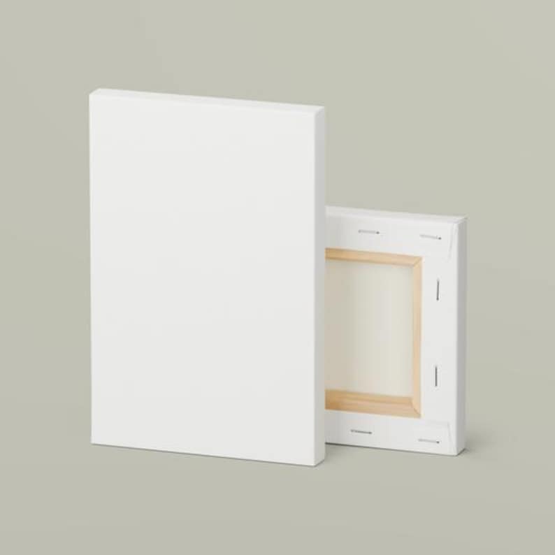 May include: A blank white rectangular canvas positioned vertically, accompanied by a second canvas showing its wooden frame structure from the back, featuring white fabric stretched over a light-colored wooden support frame with metal staples.
