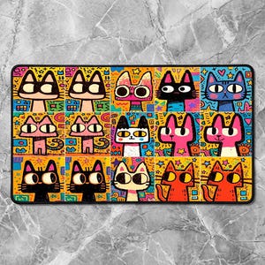 May include: A rectangular, colorful mat featuring a grid of cartoon cat faces. Each cat has a unique expression and color scheme, including pink, black, orange, and blue. The background is a mix of yellow, blue, and orange geometric patterns.