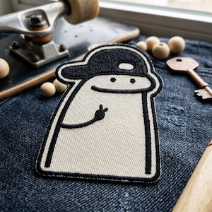 May include: A white ceramic mug with a black handle and the text "But First, Coffee" in a black, bold font. The mug is sitting on a white surface.