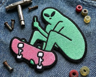 Green Alien on Pink Skateboard Embroidered Patch - Funny Outer Space Iron On Badge - Cool Streetwear Jacket Decal - Skateboarding Gift