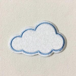 May include: A white cloud-shaped embroidered patch with a blue outline. The patch has a textured appearance and is set against a neutral background. The design is simple and clean, suitable for various applications.