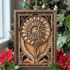 May include: A layered wooden art piece featuring a sunflower design. The artwork is framed in dark brown wood, with intricate details in lighter wood tones. The sunflower is central, with a curved stem and mountain range at the base. Red poinsettias and a Christmas tree are in the background.