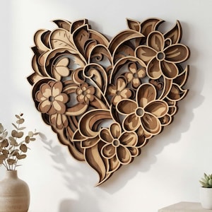 May include: Wooden heart-shaped wall art with a floral design. The artwork features layered wood in shades of brown, creating a 3D effect. The design includes flowers, leaves, and swirling patterns. A decorative piece for the home.