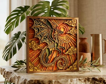 May include: A square, multi-layered wooden wall art piece featuring an intricate laser-cut dragon design. The artwork displays a dragon with detailed wings and a curled tail, set against a background of sunburst rays and stylised clouds in shades of orange, yellow, and brown.