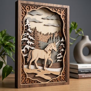 May include: Wooden layered art piece featuring a unicorn in a forest scene. The artwork has a detailed, carved frame with an intricate design. The unicorn is light brown, set against a backdrop of trees, clouds, and a mountain range.