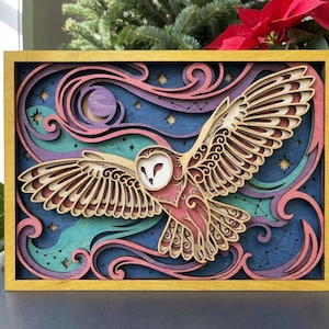 May include: A multi-layered wooden wall art piece featuring a barn owl in flight against a night sky. The design includes intricate cutouts of stars, constellations, and swirling clouds in shades of deep blue, teal, purple, and pink, all encased in a yellow frame.