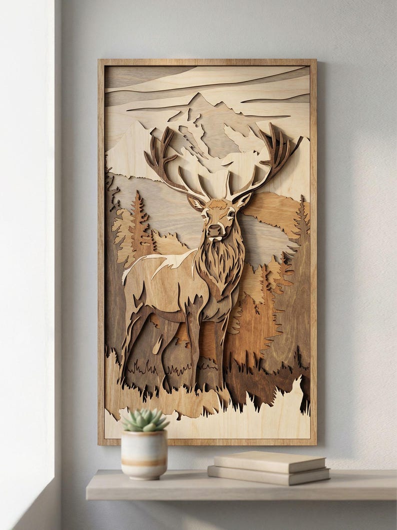May include: Wooden wall art featuring a detailed depiction of a stag in a forest scene. The artwork is crafted from layered wood, showcasing a mountain backdrop and trees. The stag has large antlers and is set within a natural, earthy color palette.