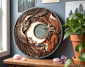 May include: A circular multi-layered wooden wall art piece featuring a carved owl with spread wings on the left and a fox on the right, surrounding a central crescent moon. The design incorporates intricate foliage patterns in shades of brown.