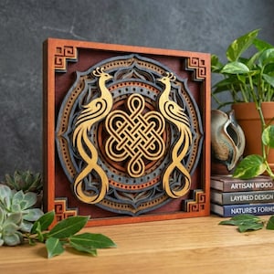 May include: A layered wooden wall art piece featuring two stylized golden phoenixes flanking a central knot design. The artwork is framed in a square, with a dark red and gray color scheme, and intricate details.