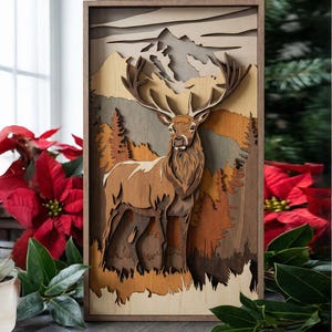 May include: A layered wooden art piece featuring a deer in a forest scene. The artwork uses various shades of brown and tan to depict the deer, trees, and mountains. The piece is framed in a wooden border, creating a three-dimensional effect.