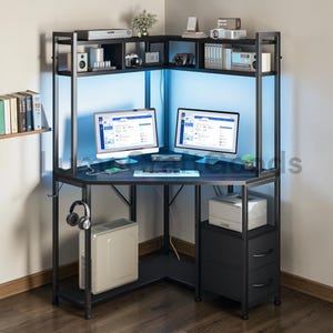 May include: A black corner computer desk with a metal frame and multiple shelves. Two computer monitors are on the desk, along with a keyboard and mouse. A computer tower, printer, and drawers are also included. The desk has a blue LED light.