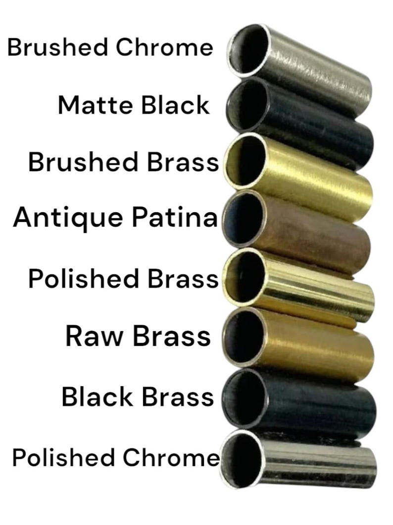 Op de afbeelding: Een verticale stapel van acht cilindrische metalen buizen in verschillende afwerkingen, gelabeld van boven naar beneden: Brushed Chrome, Matte Black, Brushed Brass, Antique Patina, Polished Brass, Raw Brass, Black Brass en Polished Chrome.