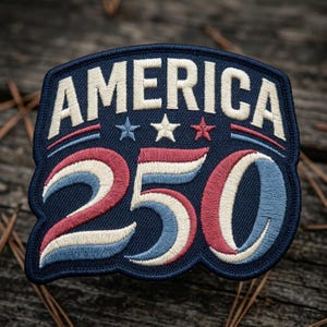 May include: Embroidered patch with the word "AMERICA" in white capital letters above the number "250". The patch features red, white, and blue colors, with three stars and stripes. The patch is navy blue.