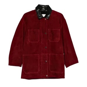 May include: A burgundy jacket with a black leather collar. The jacket has four front pockets and is buttoned up. The sleeves are three-quarter length.