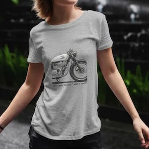 May include: A gray t-shirt featuring a black and white motorcycle graphic. The motorcycle has a white gas tank and a detailed engine. Below the graphic, the text reads, "Are you ready? Let's roll!"