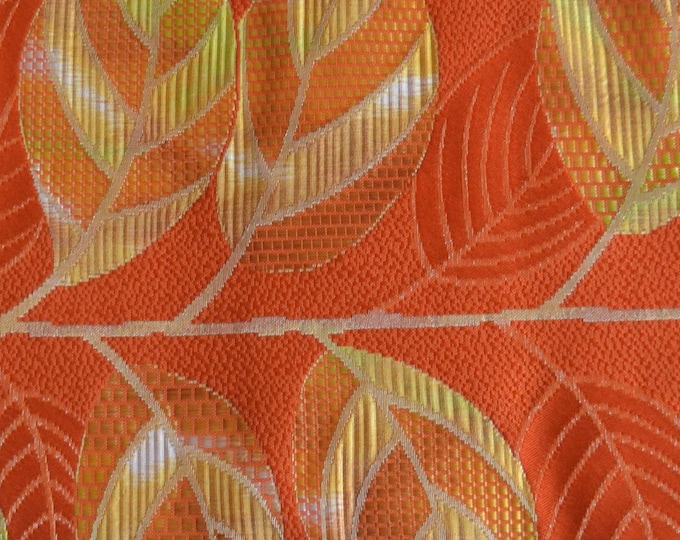 Vintage Japanese unused nagoya obi orange silk with a woven leaf pattern with gold and orange metallic thread .  plain orange reverse.