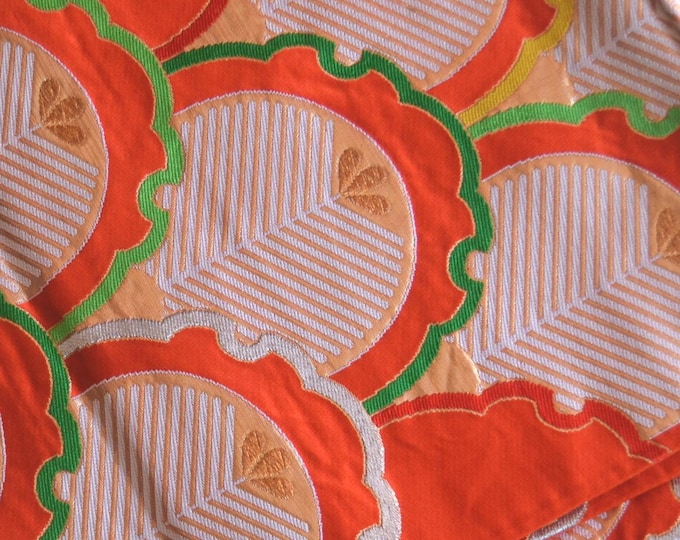 Vintage Japanese Fukuro obi dark orange silk woven . Snowflake ring pattern w/ stylized leaf design in bright colours gold metallic thread.