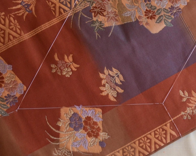 Vintage Japanese unused nagoya obi in brown, gold and purple silk.  pattern wi/ gold , metallic thread .  coloured reverse. Unopened