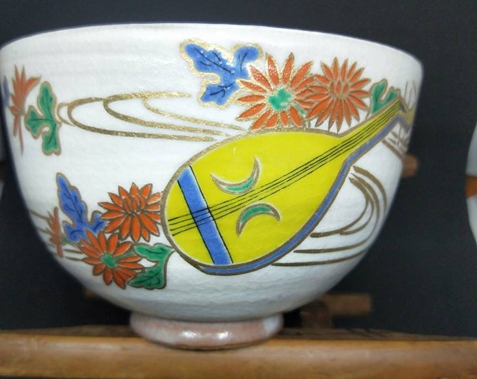 Vintage Japanese hand-made tea bowl. Kyo-ware, brown stoneware, with cream glaze and on-glaze paint Shamisen and chrysanthemum