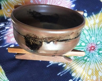 Vintage Japanese hand-made stoneware glazed tea bowl, chawan . Brown and black glaze.  Brown stoneware body.