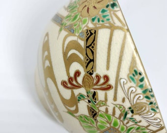 Vintage Japanese hand-made Kyoware glazed tea bowl, chawan . Painted on-glaze enamel chrysanthemum and fans.  White porcelain body.