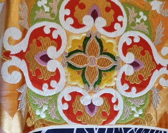 Cream and gold vintage Japanese Fukuro formal obi for kimono. Woven pattern of geometric and floral design in vibrant orange pink and blue.