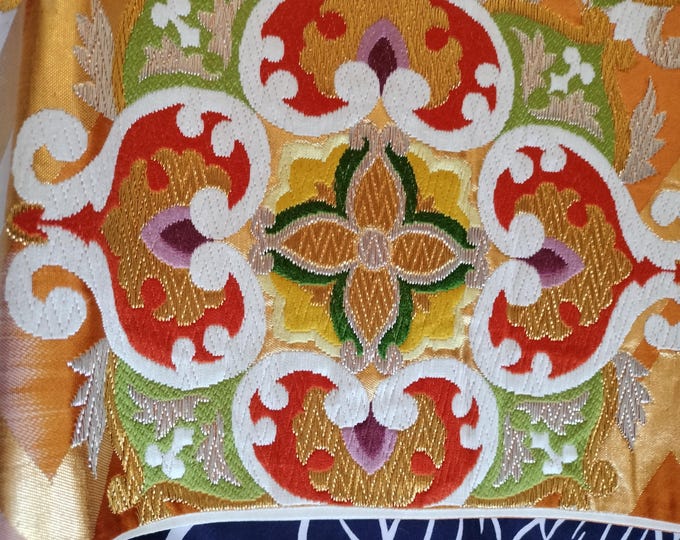 Cream and gold vintage Japanese Fukuro formal obi for kimono. Woven pattern of geometric and floral design in vibrant orange pink and blue.