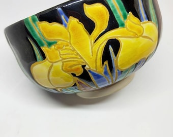 Vintage Japanese hand-made Kyoware glazed tea bowl, chawan . Painted on-glaze enamel yellow iris flowers black glaze,  white stoneware body.